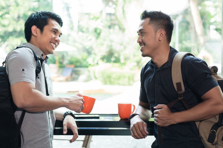 Two men connecting with each other over a coffee to avoid loneliness.